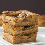 A stack of peanut butter bars on a white plate.