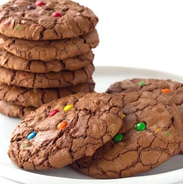 A stack of brownie cookies topped with M&M's.