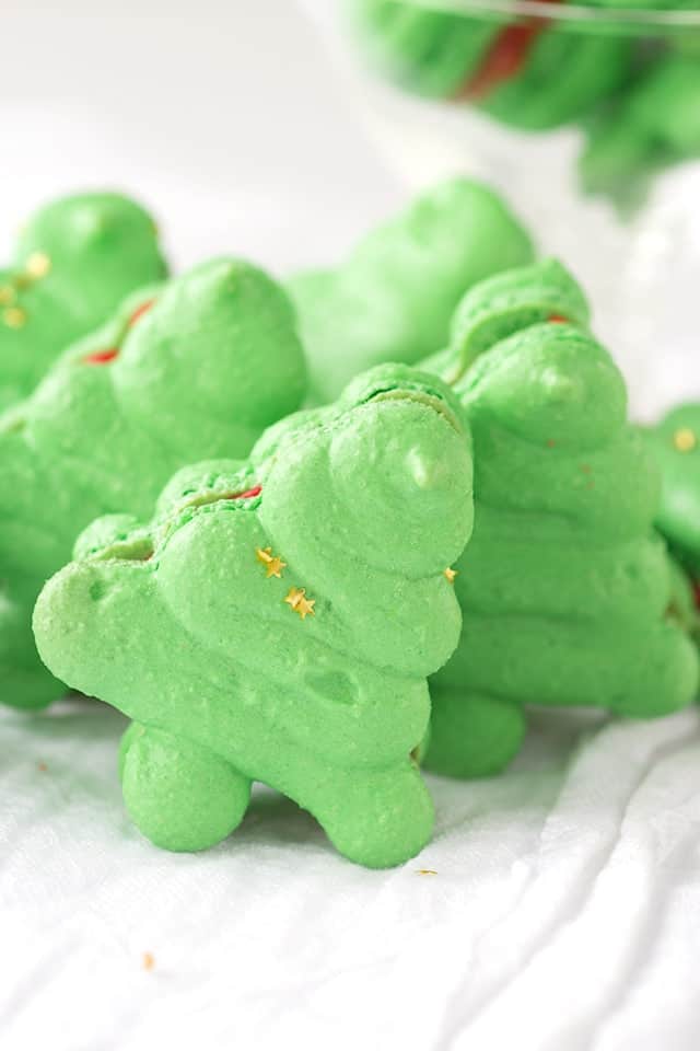 Christmas Macarons shaped like Christmas trees on a white linen