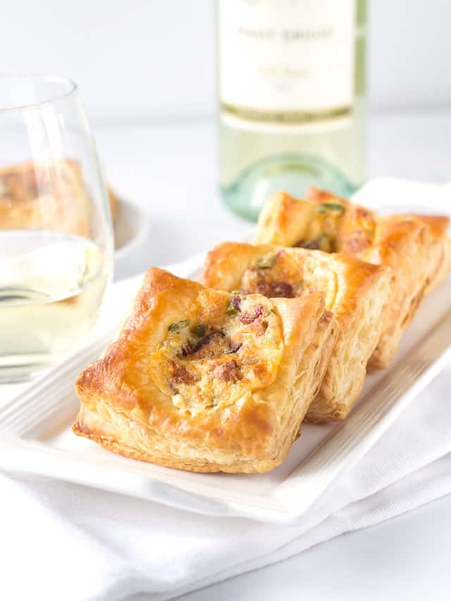A glass of white wine paired with Jalapeno Popper Bites appetizers.