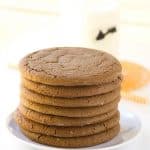 A stack of molasses cookies on a plate.