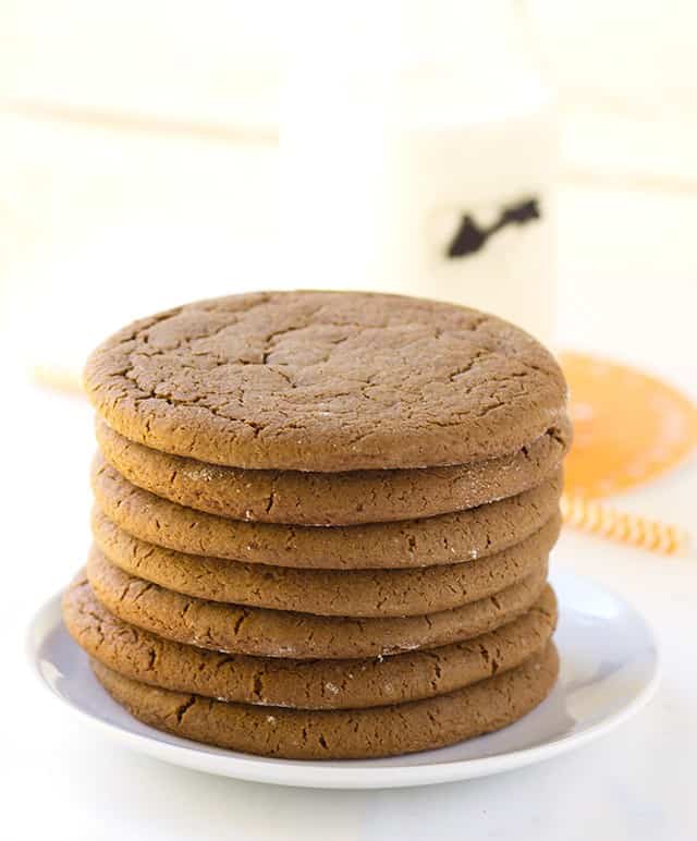 A stack of molasses cookies on a plate.