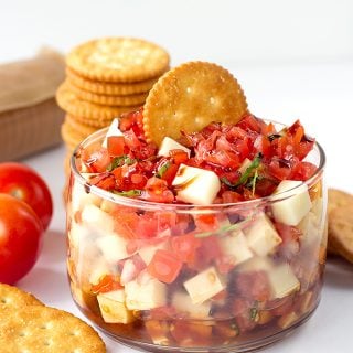A Caprese salsa with crackers.