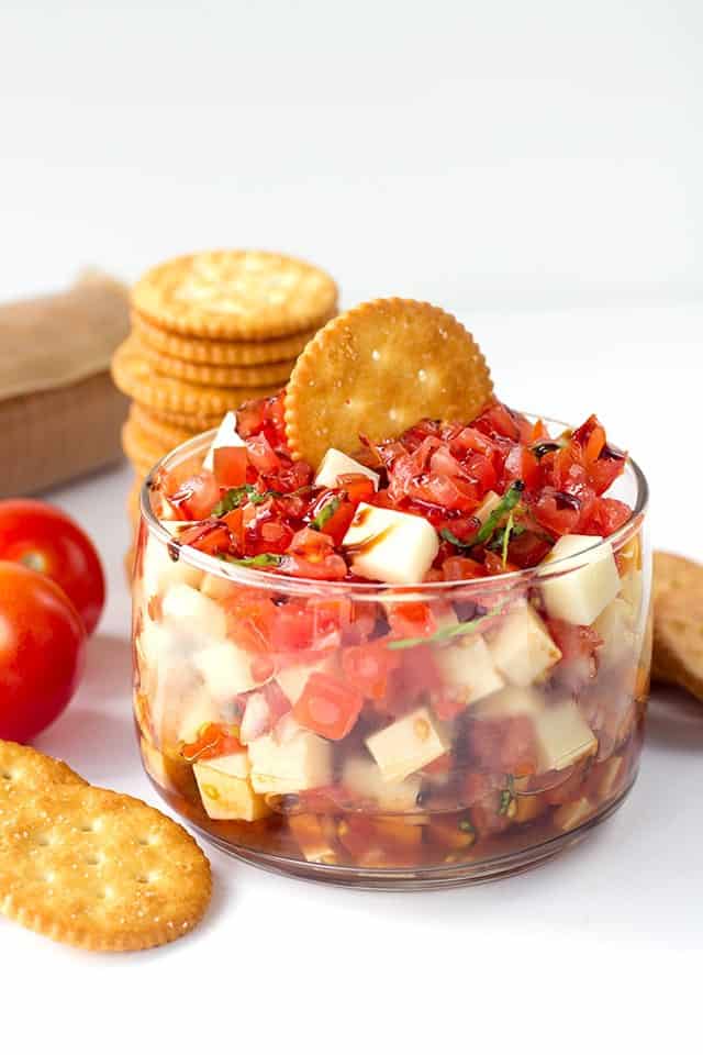 A Caprese salsa with crackers.