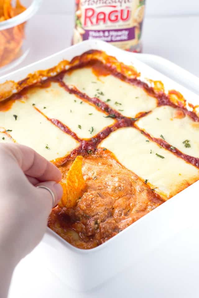 Lasagna Dip - Loaded with ricotta, mozzarella, and parmesan cheeses as well as hot sausage and Ragu sauce! This cheesy dip is amazing piled on bread or chips!