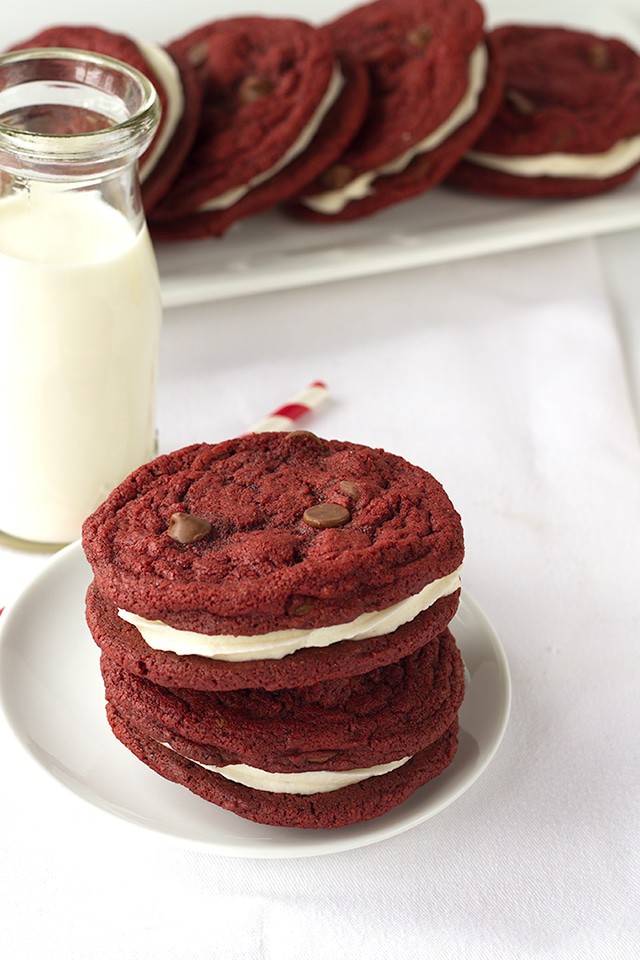Red Velvet Sandwich Cookies - Chewy red velvet chocolate chip cookies stuffed with a fluffy cream cheese frosting. 