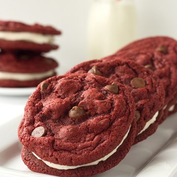 Red velvet sandwich cookies on a white plate.