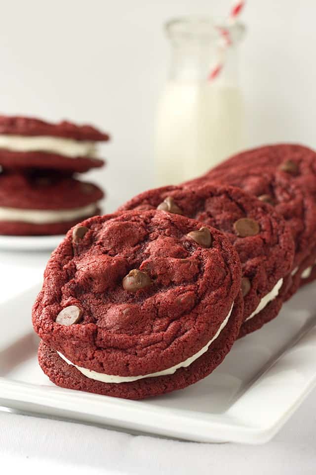 Red velvet sandwich cookies on a white plate.