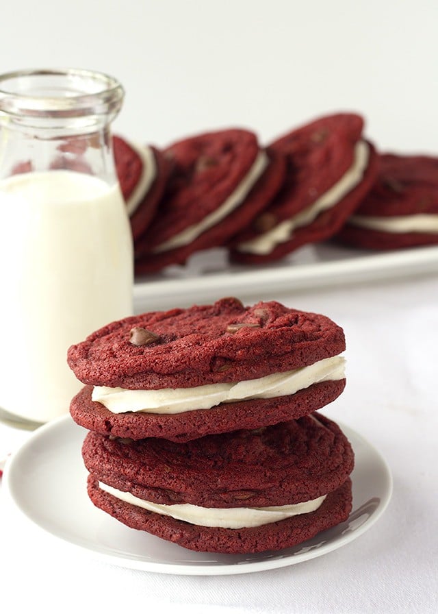 Red Velvet Sandwich Cookies - Chewy red velvet chocolate chip cookies stuffed with a fluffy cream cheese frosting. 