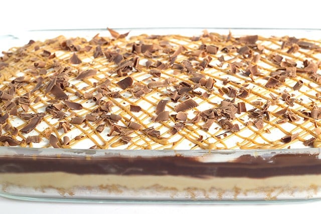 Chocolate Peanut Butter Layer Dessert - buttery pretzel crust, peanut butter cheesecake mousse, chocolate pudding, hot fudge, whipped cream and a peanut butter drizzle!