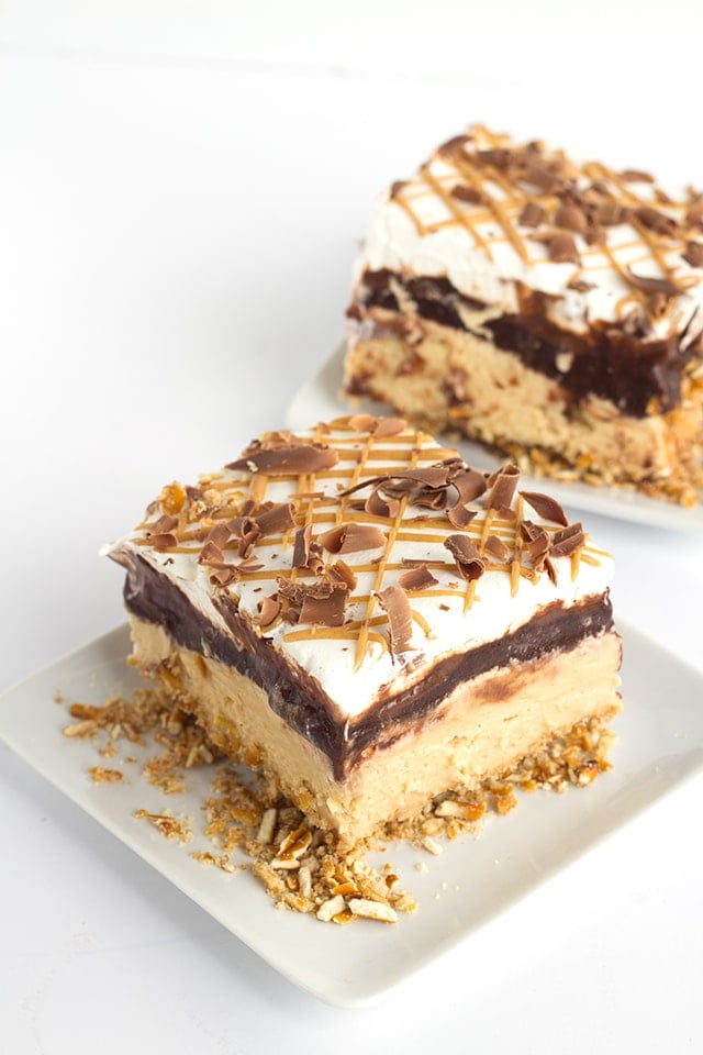 Chocolate Peanut Butter Layer Dessert - buttery pretzel crust, peanut butter cheesecake mousse, chocolate pudding, hot fudge, whipped cream and a peanut butter drizzle!