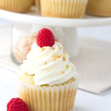 Coconut Cupcakes - coconut cupcakes stuffed with a homemade raspberry filling and topped with a high coconut frosting swirl