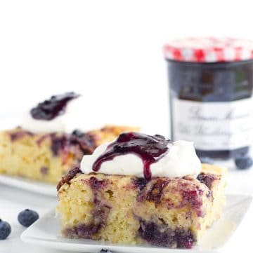 Bacon Blueberry Baked Pancakes - Need to feed a crowd or maybe just want to make a big brunch?This baked pancake done in a casserole dish is the way to go. It's packed with candied bacon, blueberry preserves, and brie cheese. Top with whipped cream and some more preserves and eat up!