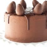 Peanut Butter Cake with Chocolate Frosting - peanut butter cake filled with chocolate frosting and chopped peanut butter cups. Top this cake with a chocolate peanut butter ganache and cute peanut butter filled chocolate eggs for EASTER!