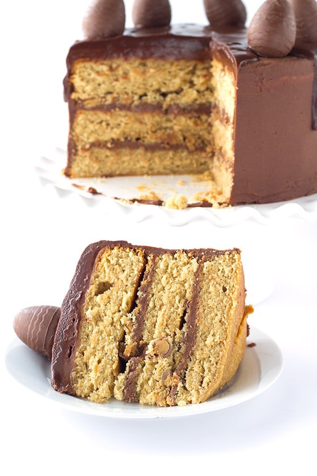 Peanut Butter Cake with Chocolate Frosting - peanut butter cake filled with chocolate frosting and chopped peanut butter cups. Top this cake with a chocolate peanut butter ganache and cute peanut butter filled chocolate eggs for EASTER! 