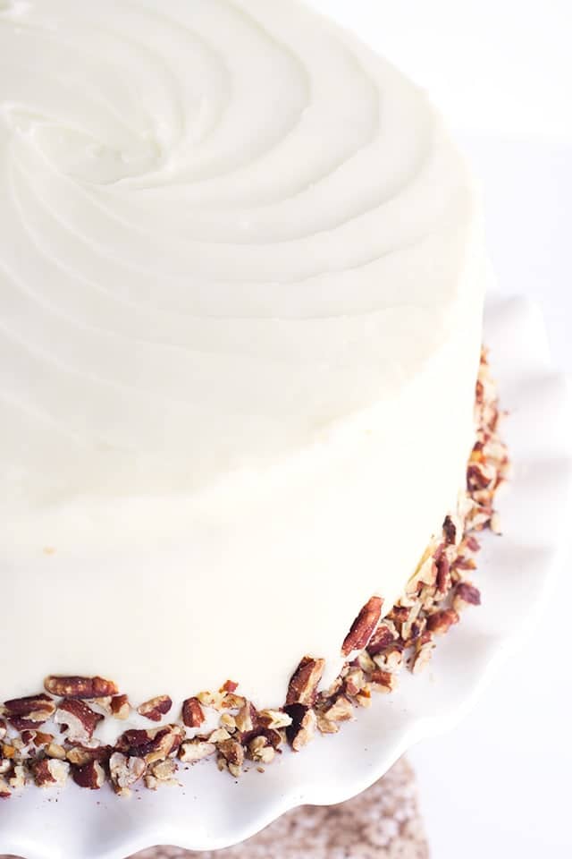 Carrot Cake with Pineapple and Cream Cheese Frosting, garnished with toasted pecans