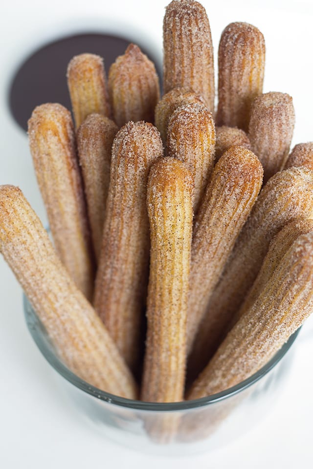 Baked Churros - These baked churros are just as good as any fried churro! It has a crunchy exterior that's been rolled in cinnamon and sugar and a tender inside. They're highly addicting and fun to dip!