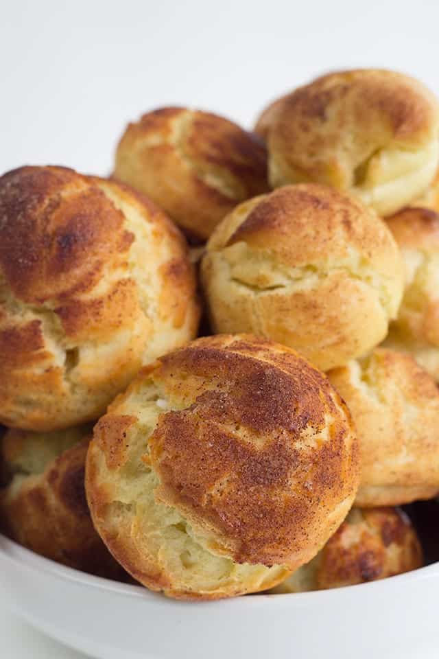 Churro Cream Puffs - easy cream puffs topped with cinnamon and sugar and filled with a cinnamon whipped cream.