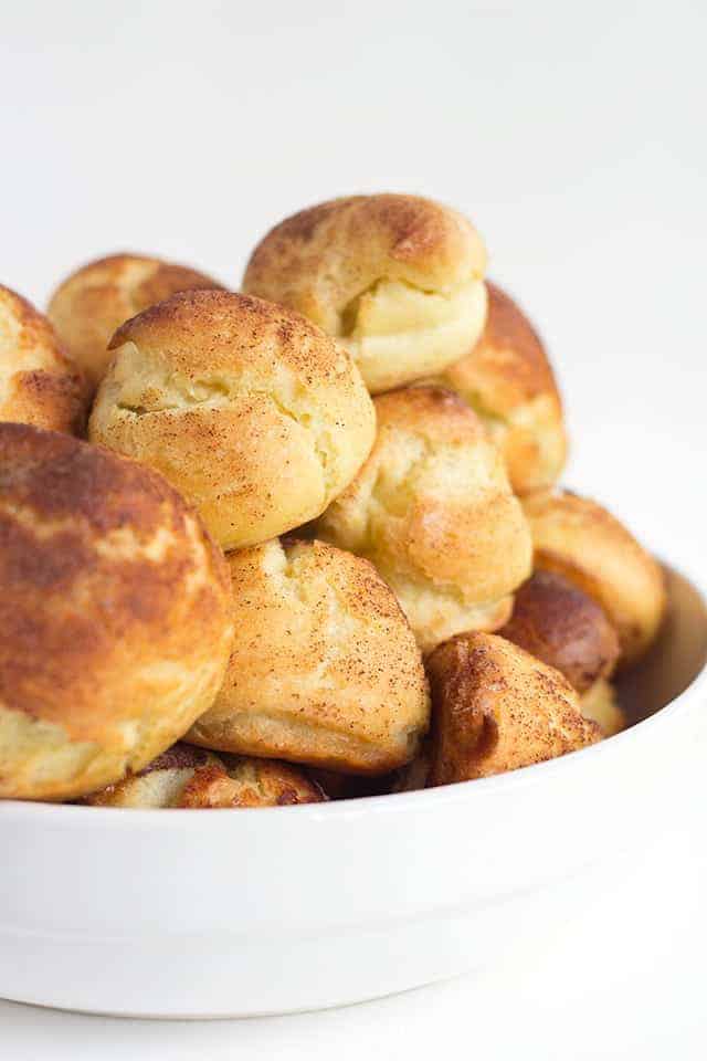 Churro Cream Puffs - easy cream puffs topped with cinnamon and sugar and filled with a cinnamon whipped cream.