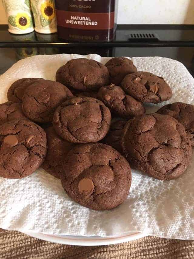 A plate of double chocolate chip pudding cookies on a paper towel
