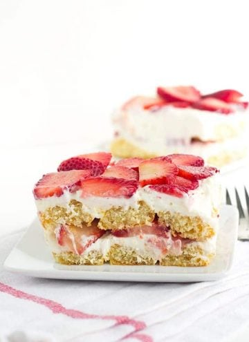 Strawberry Tiramisu - the perfect summer dessert. It's layered with strawberries, soaked in orange juice and limoncello for some bright, fun flavors.