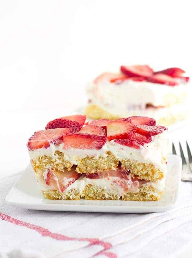 Strawberry Tiramisu - the perfect summer dessert. It's layered with strawberries, soaked in orange juice and limoncello for some bright, fun flavors. 