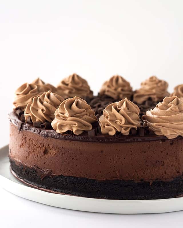 Decadent Triple Chocolate Cheesecake - I'm taking this cheesecake to the next level just for my chocolate lovers! There's a chocolate oreo crust, rich chocolate cheesecake filling and topped with a milk chocolate ganache, chocolate whipped cream and chocolate curls! 