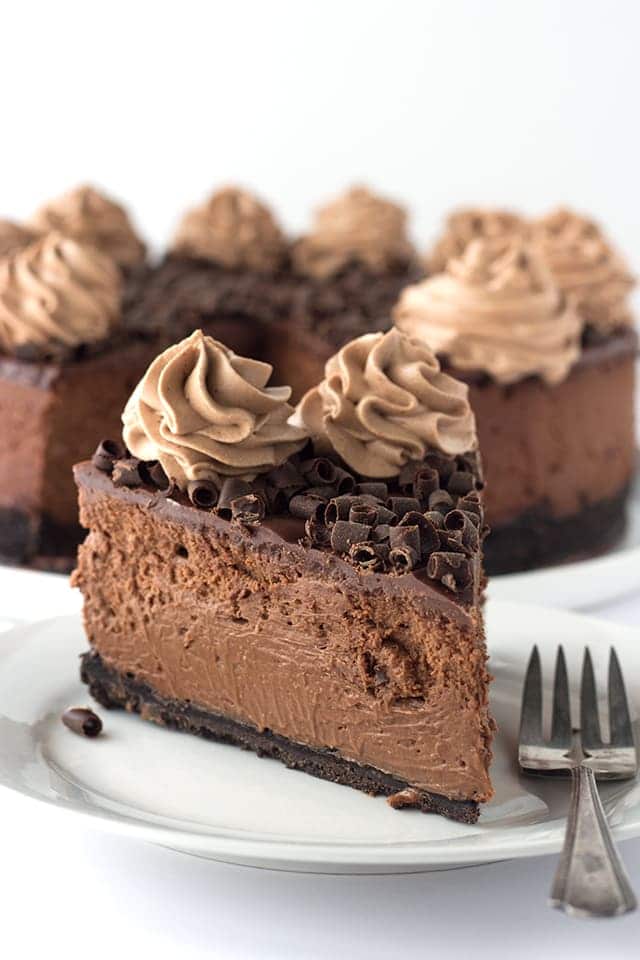 Decadent Triple Chocolate Cheesecake - I'm taking this cheesecake to the next level just for my chocolate lovers! There's a chocolate oreo crust, rich chocolate cheesecake filling and topped with a milk chocolate ganache, chocolate whipped cream and chocolate curls!