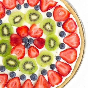 Easy Fruit Pizza - layers of sugar cookie, lemony cream cheese, and freshly sliced fruit! It's the perfect summer dessert pizza!