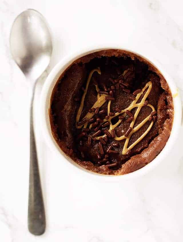 cup of chocolate peanut butter mug cake with a spoon