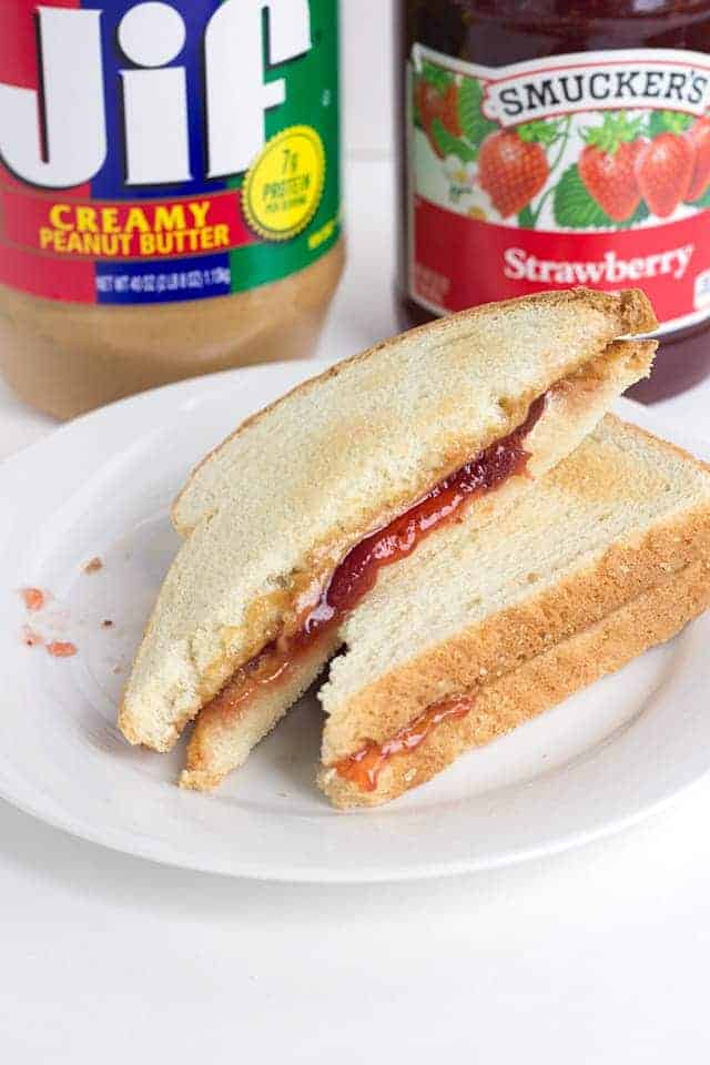 toasted peanut butter and jelly sandwich on a white plate
