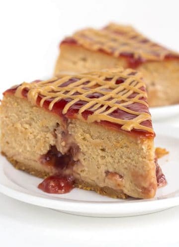Peanut Butter and Jelly Cheesecake - rich, peanut butter cheesecake with pockets of jam throughout it! Jazz the top up with jelly and a drizzle of peanut butter!