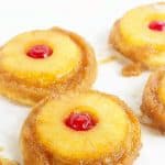 Pineapple Upside Down Sugar Cookies - Pineapple upside down cake in cookie form because everyone loves cookies! Soft sugar cookie bottoms with a ring of pineapple and cherry center all covered in a brown sugar glaze!