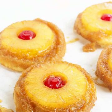 Pineapple Upside Down Sugar Cookies - Pineapple upside down cake in cookie form because everyone loves cookies! Soft sugar cookie bottoms with a ring of pineapple and cherry center all covered in a brown sugar glaze!