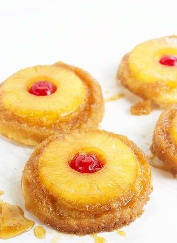 Pineapple Upside Down Sugar Cookies - Pineapple upside down cake in cookie form because everyone loves cookies! Soft sugar cookie bottoms with a ring of pineapple and cherry center all covered in a brown sugar glaze!