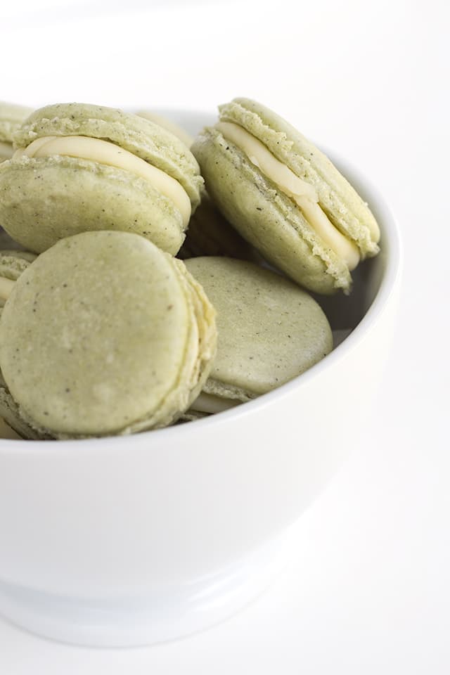 green tea french macarons in a white bowl