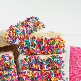 Chocolate Dipped Rice Krispie Treats on a plate with a pink fabric