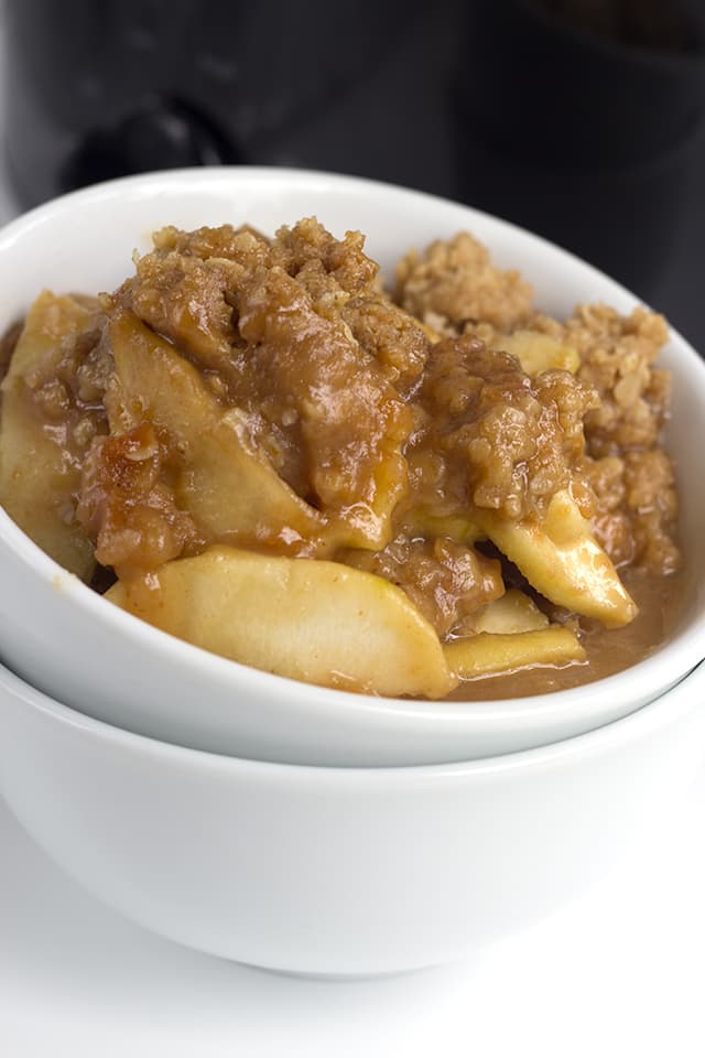 close up of the crisp topping on the slow cooker peanut butter apple crisp in white bowl