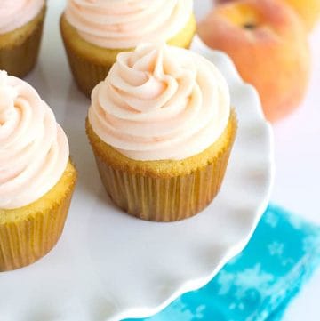 Yellow Cupcakes with Peach Cream Cheese Frosting - Light and fluffy homemade yellow cupcakes topped with a peach flavored cream cheese frosting! Perfect for all occasions!