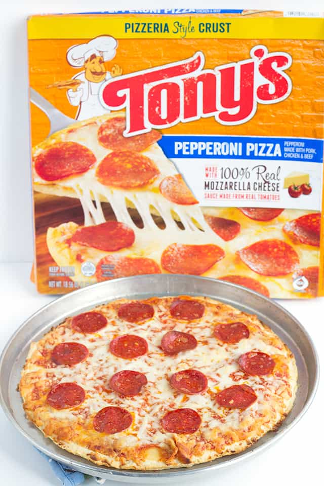 a pepperoni pizza on a sheet pan next to a Tony's pepperoni pizza box