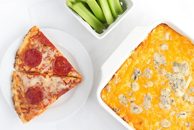 cheesy Buffalo wing dip next to slices of pepperoni pizza