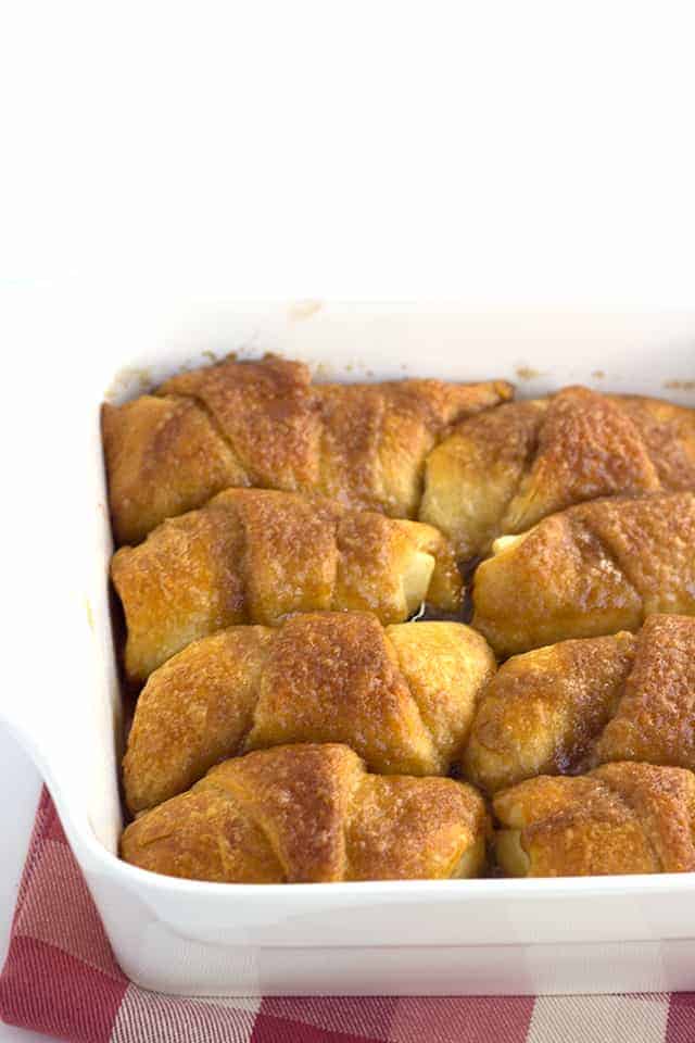 Crescent Roll Apple Dumplings - slices of apples rolled up in crescent rolls with cinnamon and sugar. Once everything is in the pan, it's coated with a layer of a buttery cinnamon brown sugar mixture and baked.