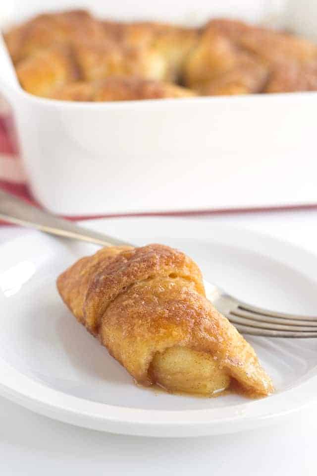 Crescent Roll Apple Dumplings - slices of apples rolled up in crescent rolls with cinnamon and sugar. Once everything is in the pan, it's coated with a layer of a buttery cinnamon brown sugar mixture and baked.