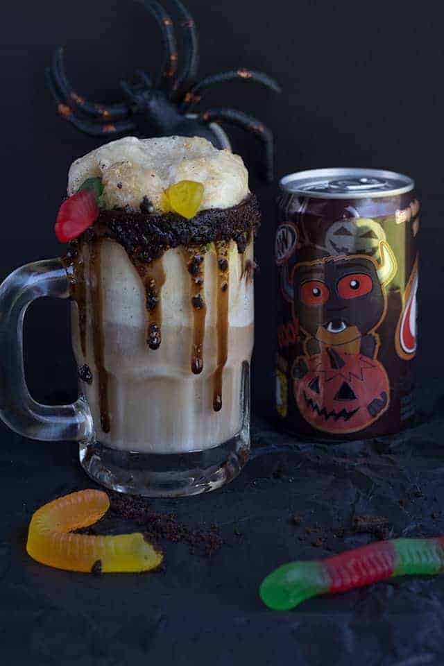 Dirt Cake Root Beer Float - The perfect spooky float for the kids! It has all the great flavors of the original float with a twist of chocolate cookie, chocolate syrup, and gummi worms!