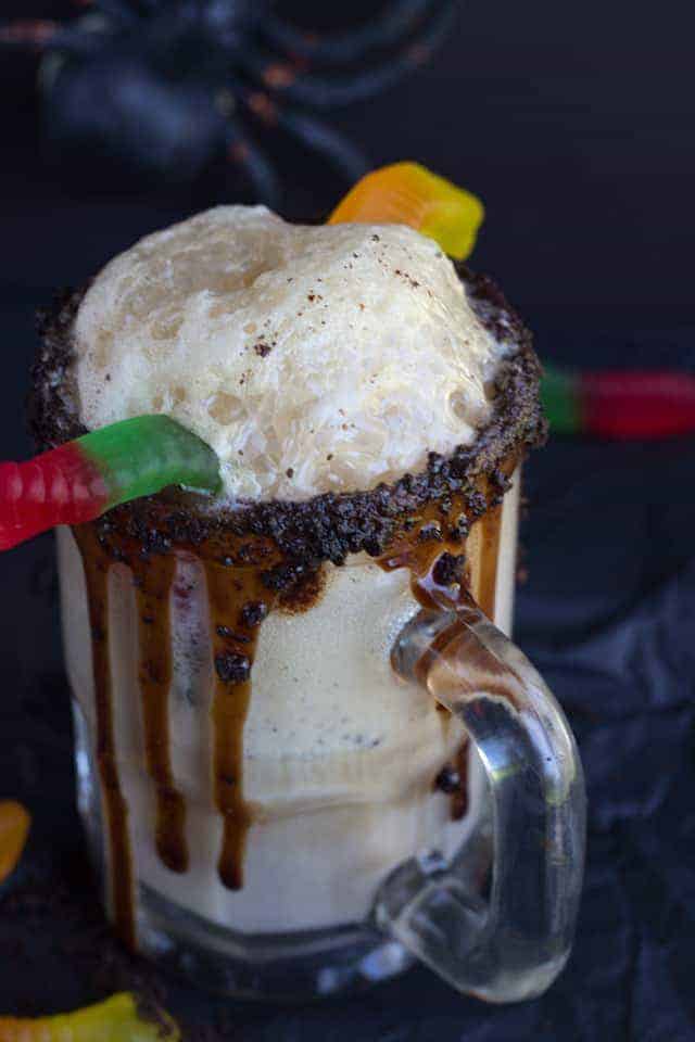 Dirt Cake Root Beer Float - The perfect spooky float for the kids! It has all the great flavors of the original float with a twist of chocolate cookie, chocolate syrup, and gummi worms!