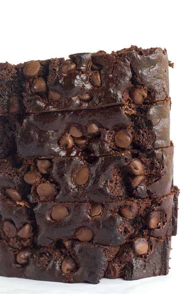 A stack of double chocolate brownies on a white background.