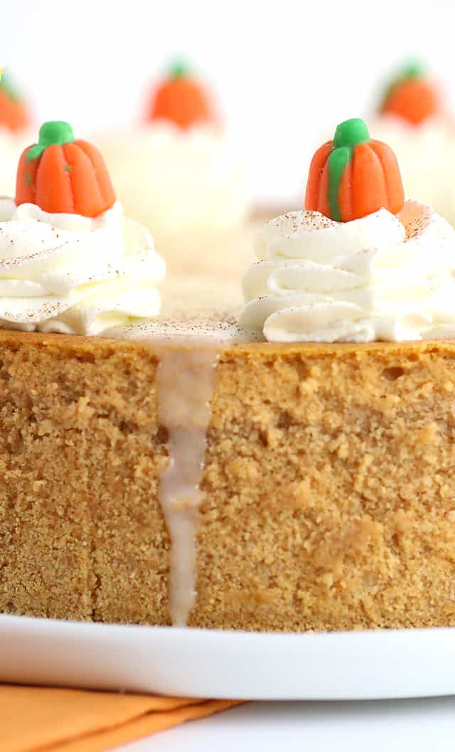 Pumpkin Cheesecake - Thick, creamy cheesecake stuffed full of all the right spices for a pumpkin pie! To finish the pumpkin cheesecake off, I added a maple white chocolate ganache, whipped cream, a dusting of cinnamon, and cute little candy pumpkins! This would be a hit for Thanksgiving dessert!