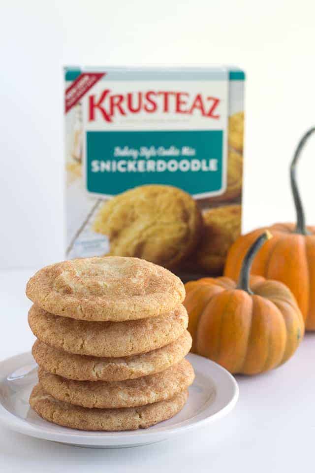 Pumpkin Cheesecake Snickerdoodles - These cookies are the perfect shortcut cookies for a holiday cookie tray.. They are stuffed with a creamy pumpkin cheesecake filling that adds an additional bit of flavor! The outside is slightly crunchy from the cinnamon sugar coating.