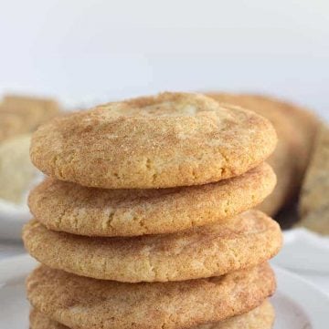 Pumpkin Cheesecake Snickerdoodles - These cookies are the perfect shortcut cookies for a holiday cookie tray.. They are stuffed with a creamy pumpkin cheesecake filling that adds an additional bit of flavor! The outside is slightly crunchy from the cinnamon sugar coating.