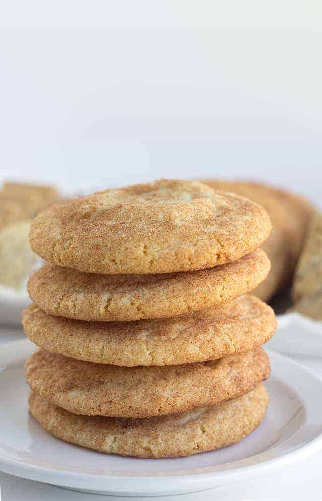 Pumpkin Cheesecake Snickerdoodles - These cookies are the perfect shortcut cookies for a holiday cookie tray.. They are stuffed with a creamy pumpkin cheesecake filling that adds an additional bit of flavor! The outside is slightly crunchy from the cinnamon sugar coating. 